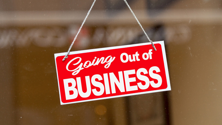 A red "Going out of business" sign on store window