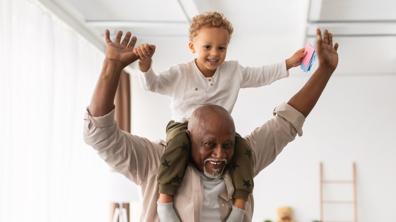 grandfather with grandson sitting on his shoulders