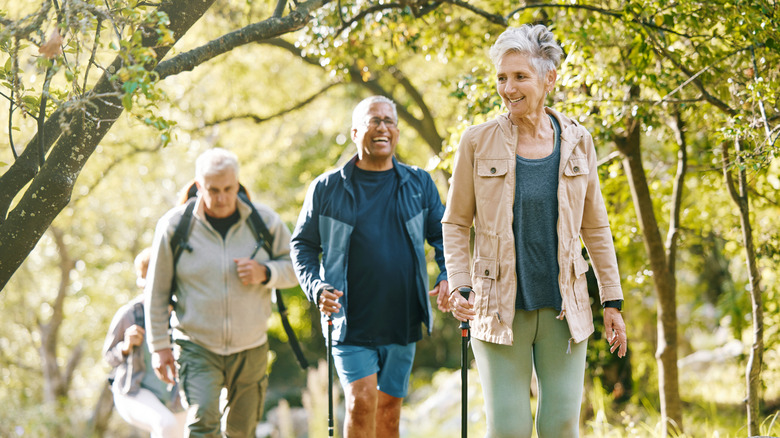 hiking group of older adults led by older woman