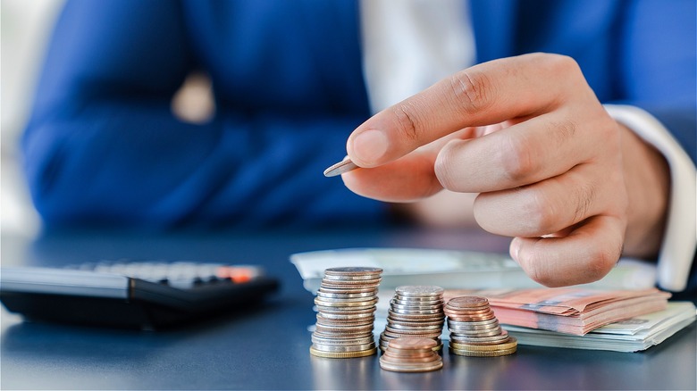 Person holding coin, counting coins