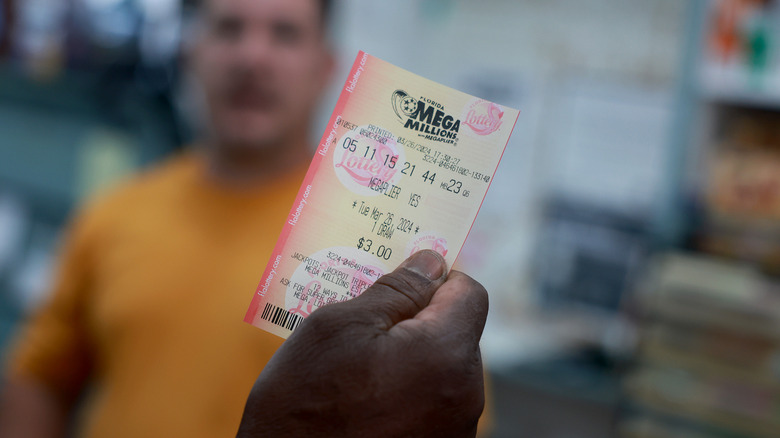 A customer purchases a Mega Million lottery ticket at the La Esquina Tropical supermarket