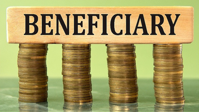 A block with the word "beneficiary" on top of four stacks of coins