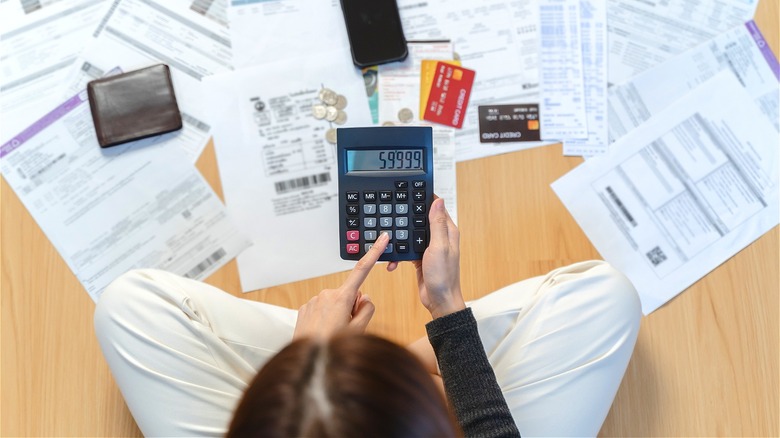 Personal calculating debts on floor