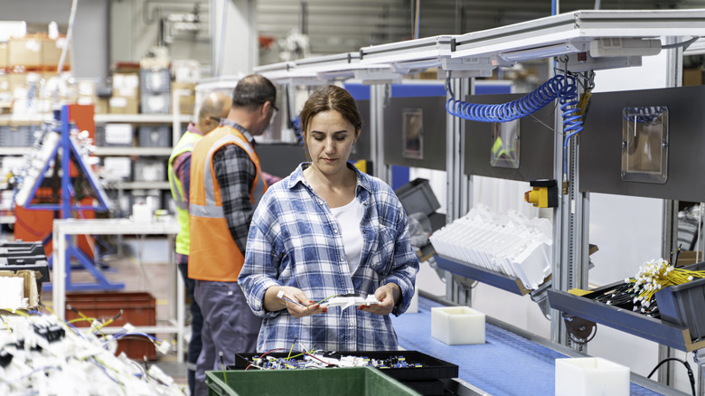 Industrial factory workers at an assembly line