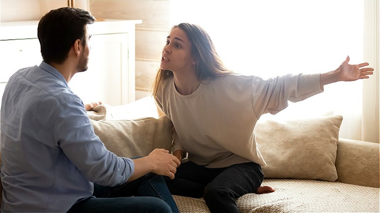 Emotional couple arguing at home