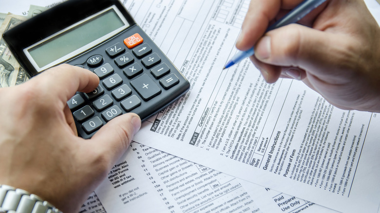 Cropped image of Businessman calculating and checking tax 2018 year