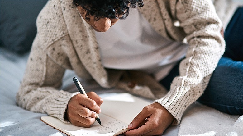 Person writing in journal