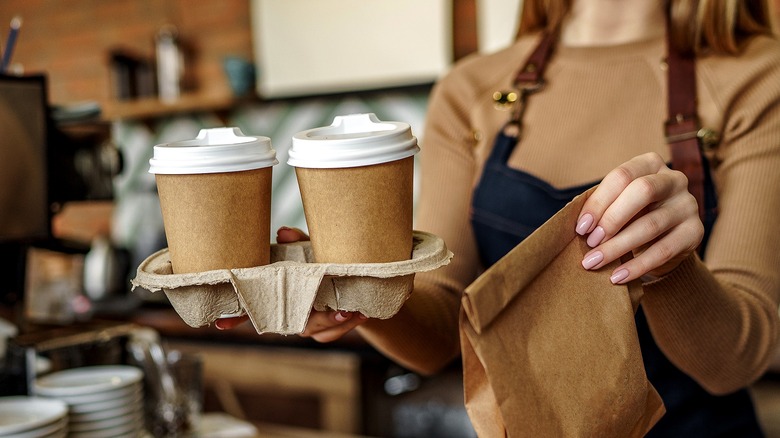 Barista handing over coffee order