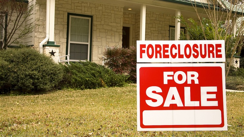 House with foreclosure sign