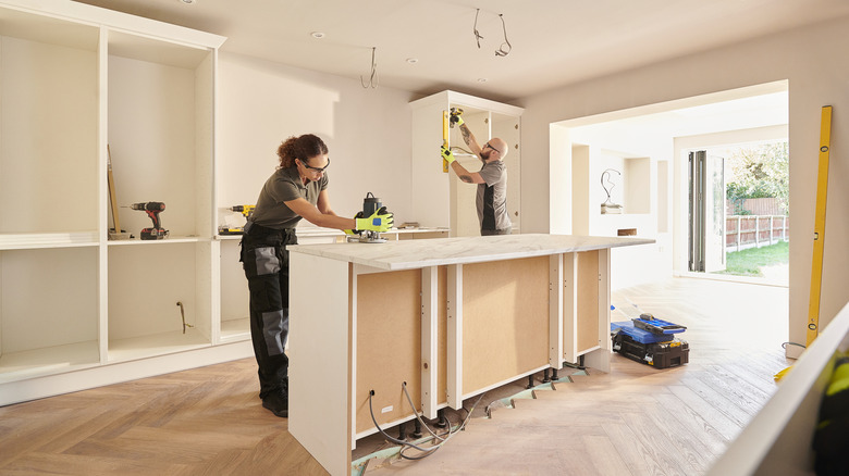 team installing cabinets