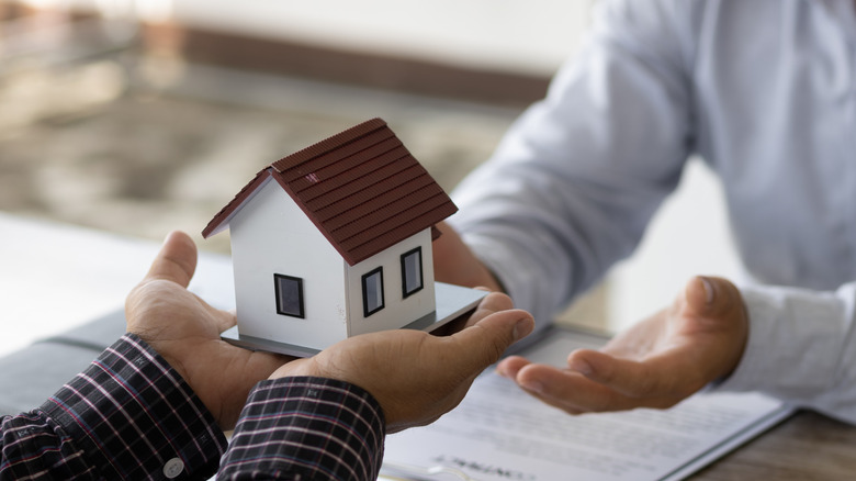 handing over house figure