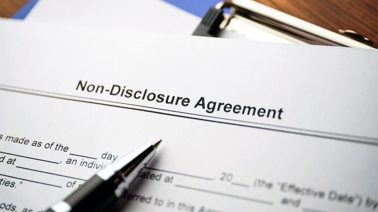Close up of a non-disclosure agreement document on a blue clipboard.