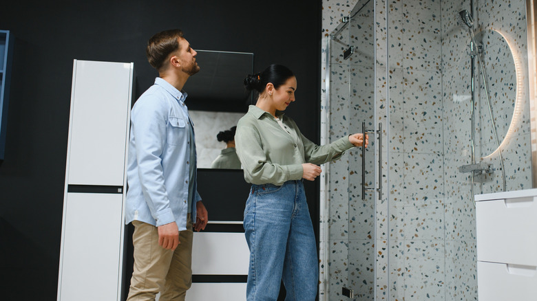 Couple examining a shower display