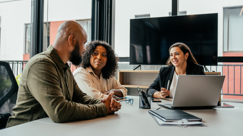 A young couple talking to a financial advisor