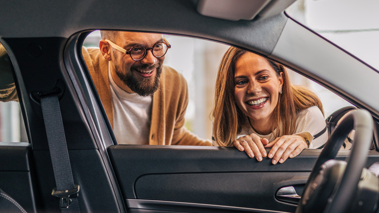 couple looking in a car window