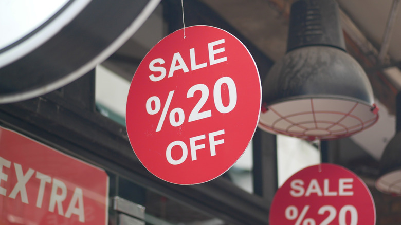 Close up of sale signs hanging in a store