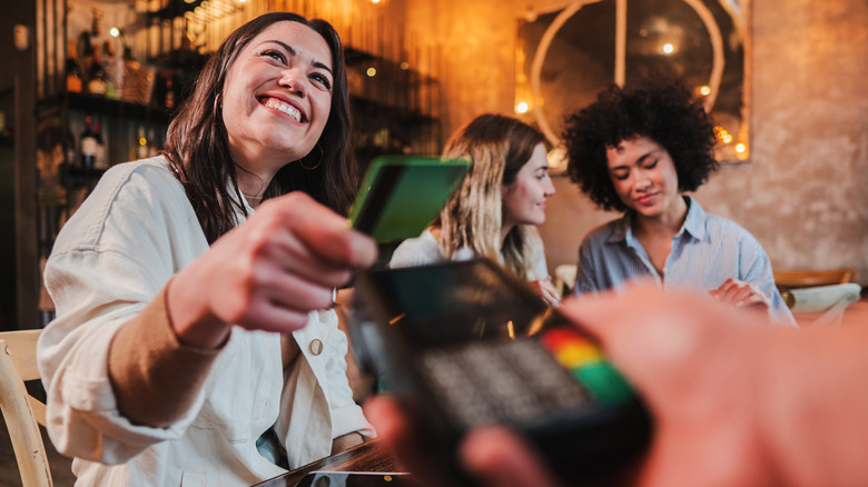 Woman paying with credit card