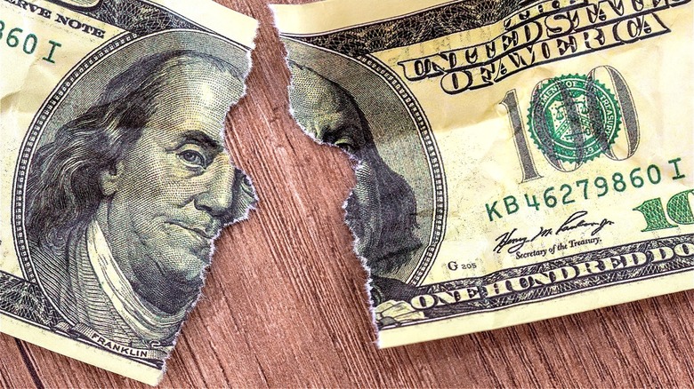 $100 bill ripped in half