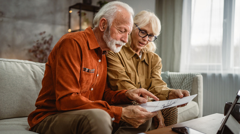 Senior couple looking at bills.