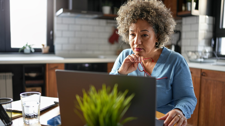 Senior woman looking at laptop.