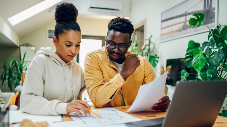 Young couple reviewing paperwork.