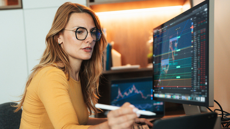 Woman looking over stock charts