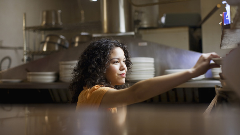 Woman working in a restaurant kitchen