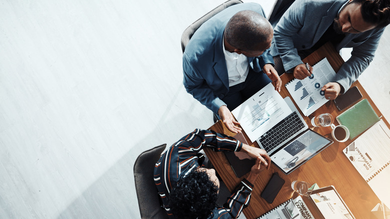 overhead view of people working at a desk