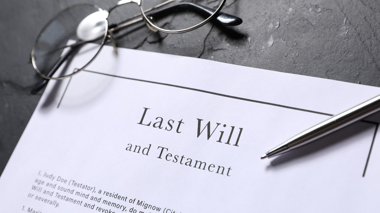 Pair of eyeglasses rests on document that reads last will and testament