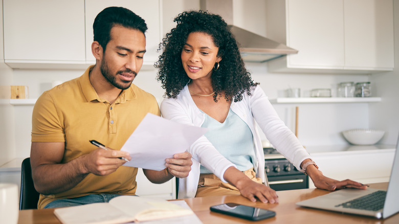 Couple studying financial documents