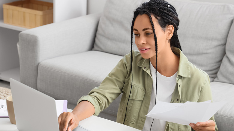A young woman paying her taxes