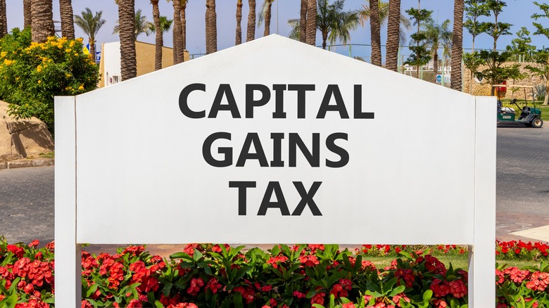 A large outdoor sign reading 'capital gains tax'