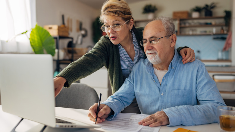 Elderly couple looking at a computer screen