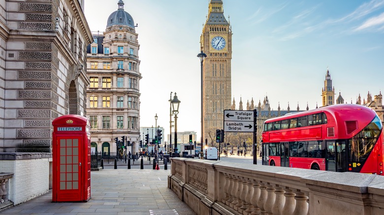 London street with phone booth and bus and Big Ben clock tower in the background