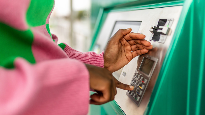 Person hiding pinpad while using an ATM