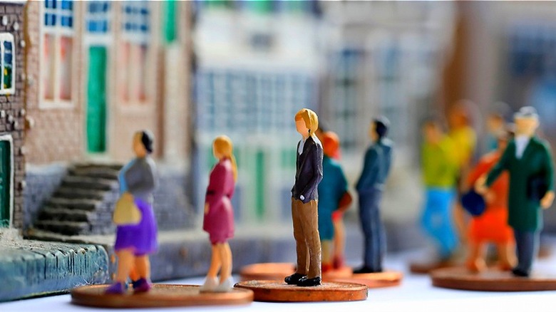 People figurines outside row home