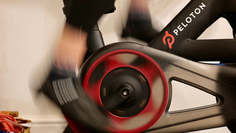 Close up of someone using a Peloton bike indoors.