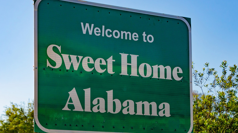 Road sign reading "Welcome To Sweet Home Alabama"