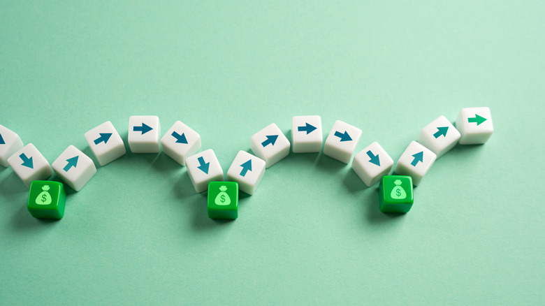 arrows jumping from one money bag block to another