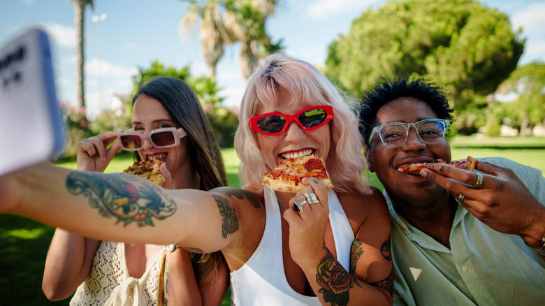 young people eating pizza
