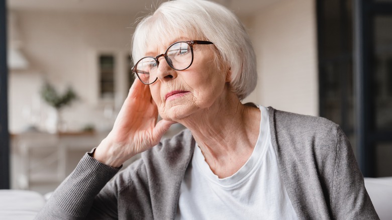 Senior woman in glasses concerned