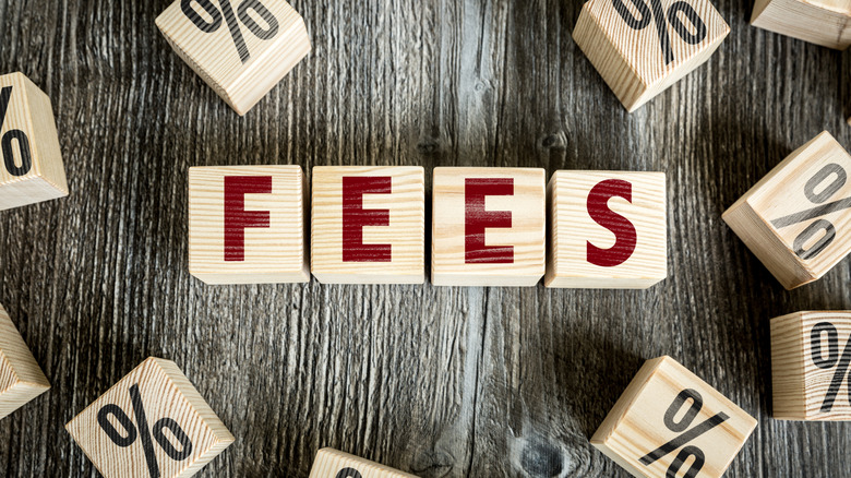 "Fees" written in blocks with percentage icons around it
