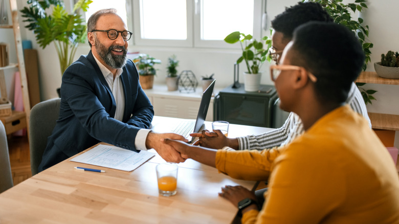 A banker shaking hands with clients