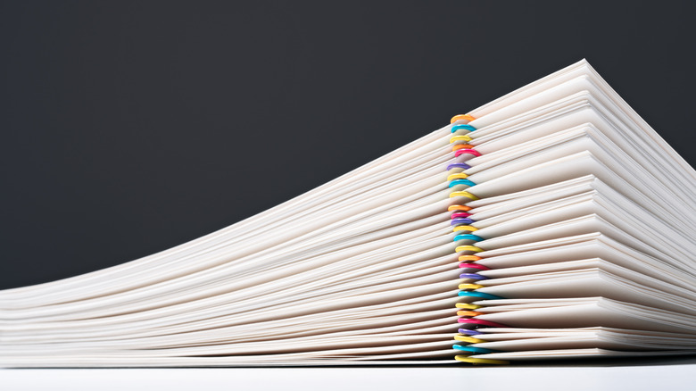 a stack of financial records with paperclips separating documents