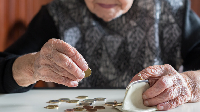 Elderly women counting coins