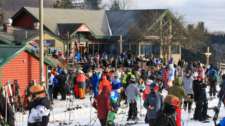 A large group of skiers at a ski lodge in Vermont.