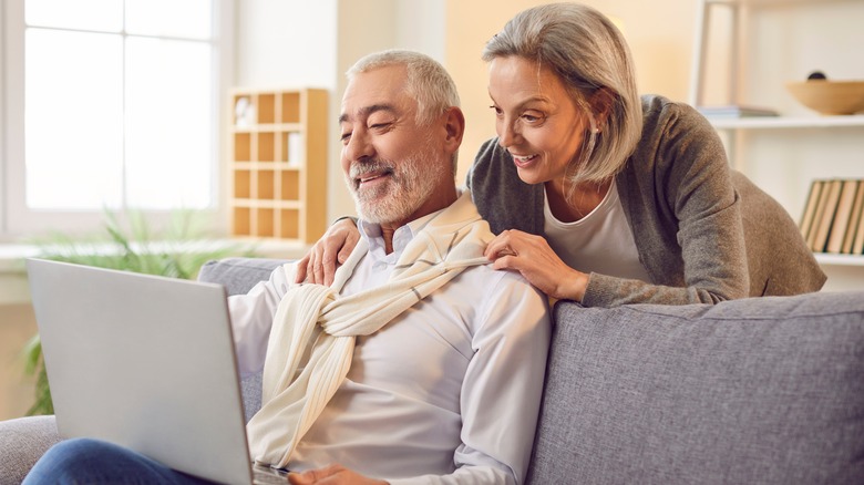 Older couple in a nice home looking at a laptop