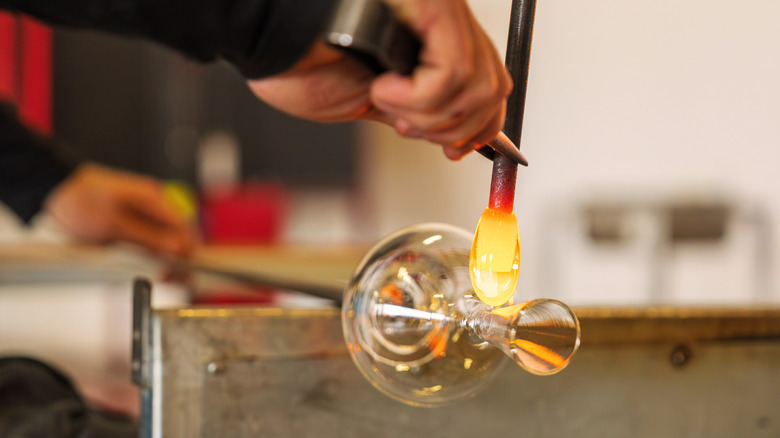 Glassblower shaping glass in Murano