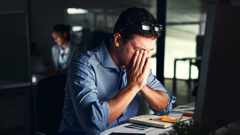 Person stressed in front of computer.