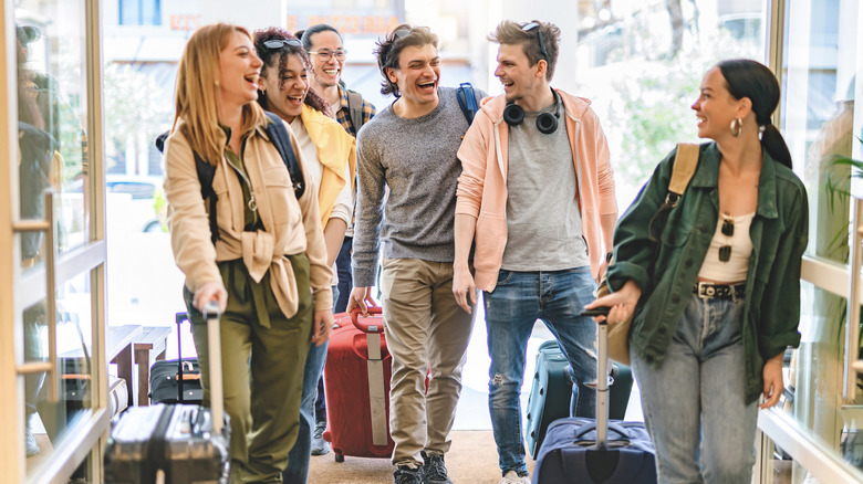 Group of young people with luggage.